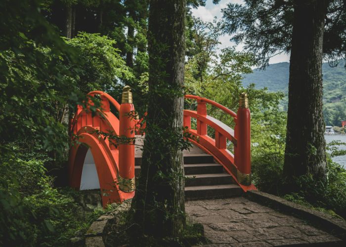 A bright red bridge at Hakone Shrine, next to Lake Ashi.